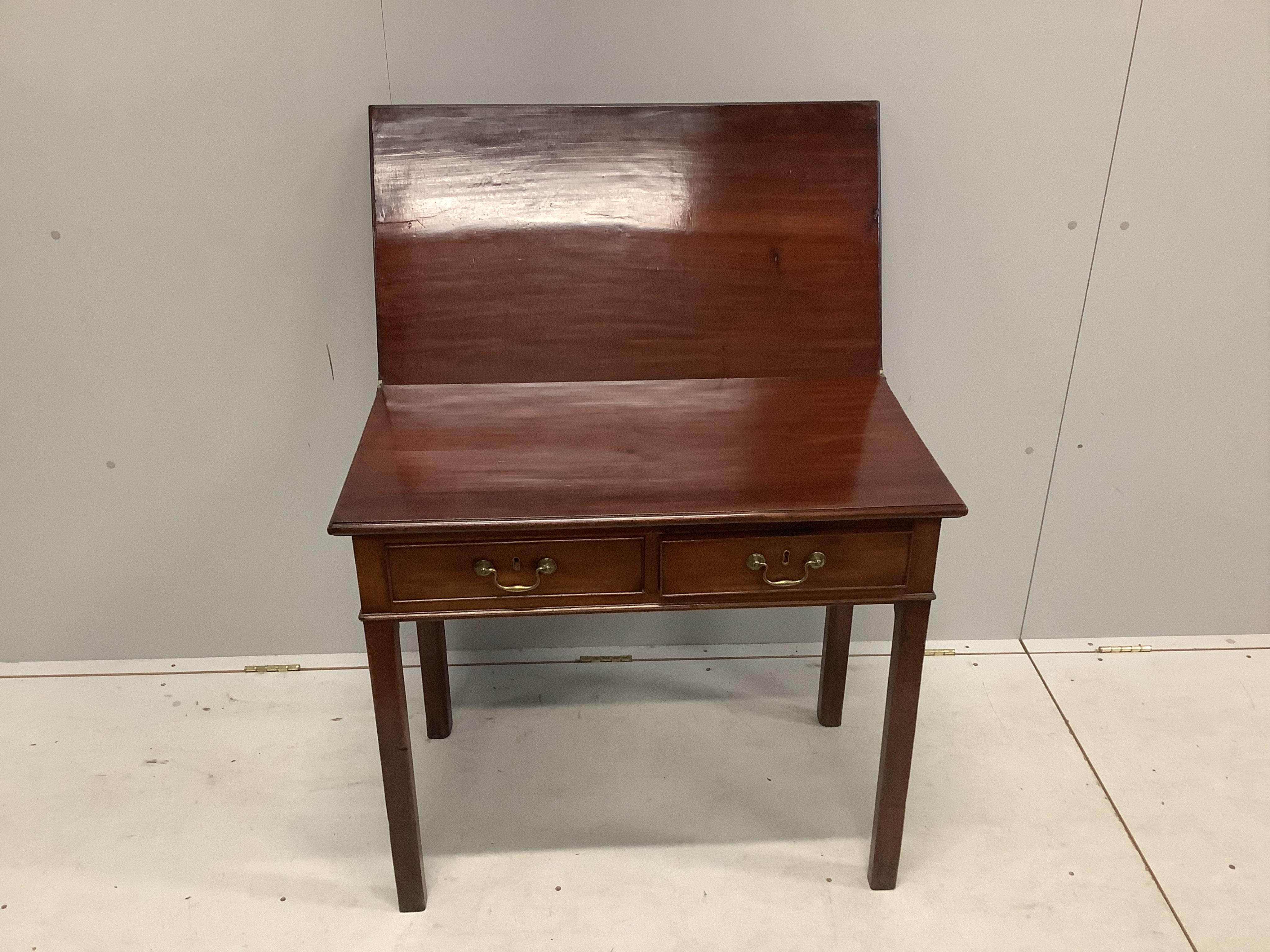 A George III rectangular mahogany two drawer folding tea table, width 83cm, depth 45cm, height 73cm. Condition - fair to good